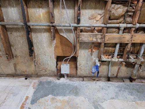 Repairs to washroom walls in front locker room